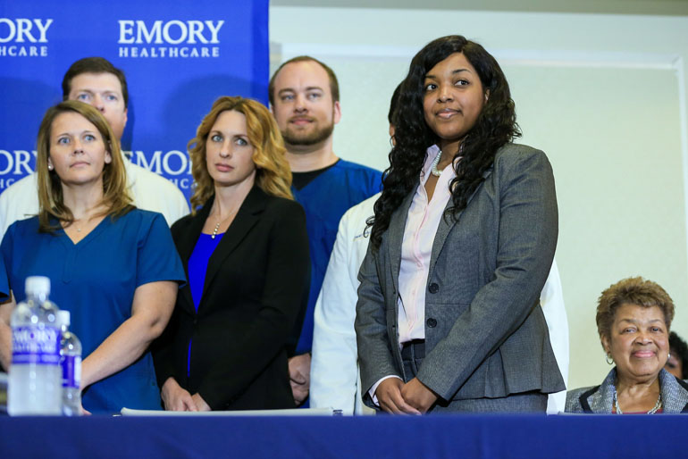 Amber Vinson (2nd R), a Texas nurse who contracted Ebola after treating an infected patient, stands with her nursing team during a press conference after being released from care at Emory University Hospital on August 1, 2014 in Atlanta, Georgia. (Photo by Daniel Shirey/Getty Images)