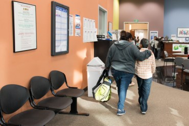 Marcy Valenzuela leaves the Department of Public Social Services El Monte office with her younger brother after being told she needs to return to complete her Medi-cal application (Photo by Heidi de Marco/KHN).