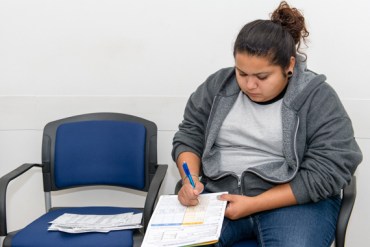 Marcy Valenzuela, 25, applies for Medi-Cal at the Department of Public Social Services in El Monte, Calif., after being uninsured for the last four years (Photo by Heidi de Marco/KHN).
