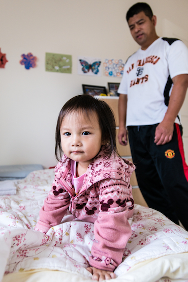 Jack Liu, 45, watches over three-year-old daughter Fiona Liu on Saturday, December 6, 2014. The Liu’s decided he would stay home to take care of the children instead of paying for daycare (Photo by Heidi de Marco).