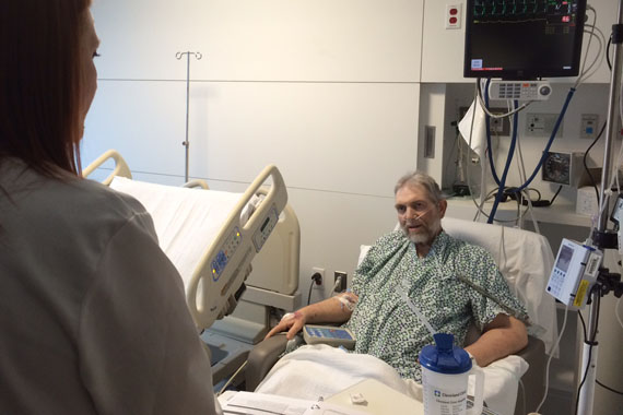 Cleveland Clinic Pharmacist Katie Greenlee talks with Morgan Clay about the correct way to take his prescriptions after being discharged. (Photo by Sarah Jane Tribble/WCPN)