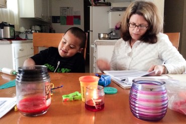 Sarah Boone, a behavior analyst with the social services agency EMQ FamiliesFirst, evaluates Ernesto Chairez, 6, of San Jose for autism therapy services. (Photo by Barbara Feder Ostrov)