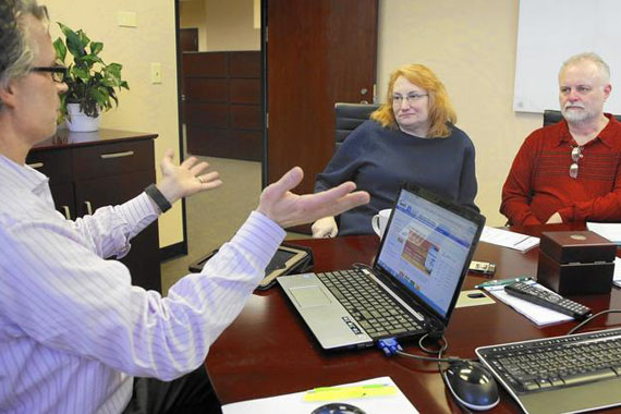 Naperville, Ill., insurance agent Robert Slayton talks to potential clients Jeanne and Ralph Wysocki on Jan. 8, 2015. (Photo by Chuck Berman/Chicago Tribune)
