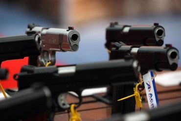 Handguns are displayed in the Remington booth during the 2013 NRA Annual Meeting and Exhibits at the George R. Brown Convention Center on May 5, 2013 in Houston, Texas.  (Photo by Justin Sullivan/Getty Images)