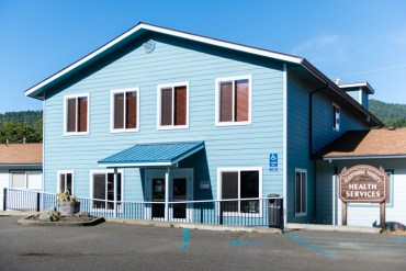 The clinic, a remodeled blue cottage, used to serve as the local forest service office (Photo by Heidi de Marco/KHN).