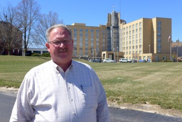 Belleville, Ill., Mayor Mark Eckert outside St. Elizabeth’s Hospital which is across from St. Peter’s Cathedral in downtown Belleville. (Photo by Phil Galewitz/KHN)