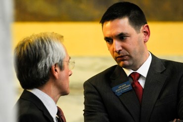 Montana House Minority Leader Chuck Hunter, D-Helena, and House Speaker Austin Knudsen, R-Culbertson, speak during a House Floor session Tuesday April 7, 2015, in Helena, Mont. A House committee tried to kill the last-standing Medicaid expansion bill Tuesday by heavily amending it and giving it an unfavorable report. (AP Photo/The Independent Record, Thom Bridge)