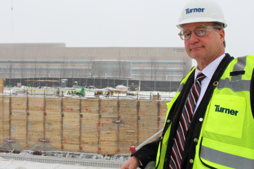 Cliff Kazmierczak of Turner Construction stands overlooking the construction site for the Cleveland Clinic's planned cancer outpatient center. (Sarah Jane Tribble/WCPN)