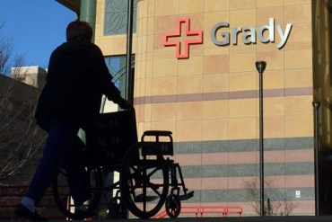 An employee returns a wheelchair to Grady Memorial Hospital after escorting a patient to their car Thursday January 16, 2014. (Photo by Brant Sanderlin/Atlanta Journal-Constitution)