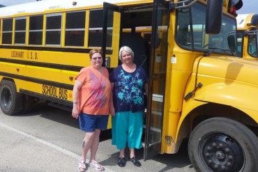 Billie Pender, a 58-year-old retired school bus driver and her sister,  Martha Sherwood, 62, who oversees Lockhart’s school bus program. (Photo by Julie Appleby/KHN)