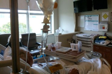 One of the screen's in Richard Gilbert's hospital room is a TV. The other is an eICU screen, that lets him see and converse with an extra nurse who checks on his care. (Photo by Michael Tomsic/WFAE)