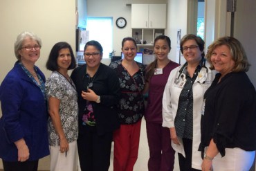 The staff at the Charlotte Community Health Clinic: Nancy Hudson (left), Maria Elena Solanilla, RN; Tonya Luna, CMA; Lisa Ortiz-Fraticelli, RN; Charm May Agustin, CMA; Martha Brinsko, FNP; Tamara Withers-Thompson, RN. (Photo by Michael Tomsic/WFAE)