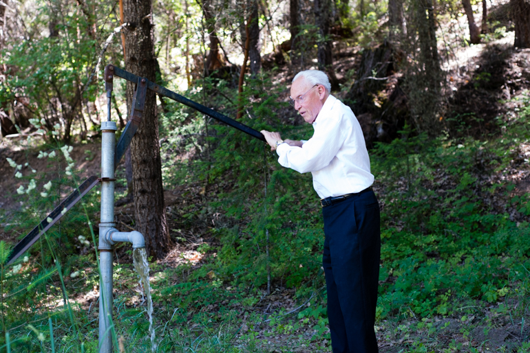 Dr. Earl Mercill pushes the lever of the water pump he built in the backyard of his house in Hayfork, California, on June 18, 2014. The 91-year-old takes daily walks around his 40-acre property daily (Photo by Heidi de Marco/KHN).