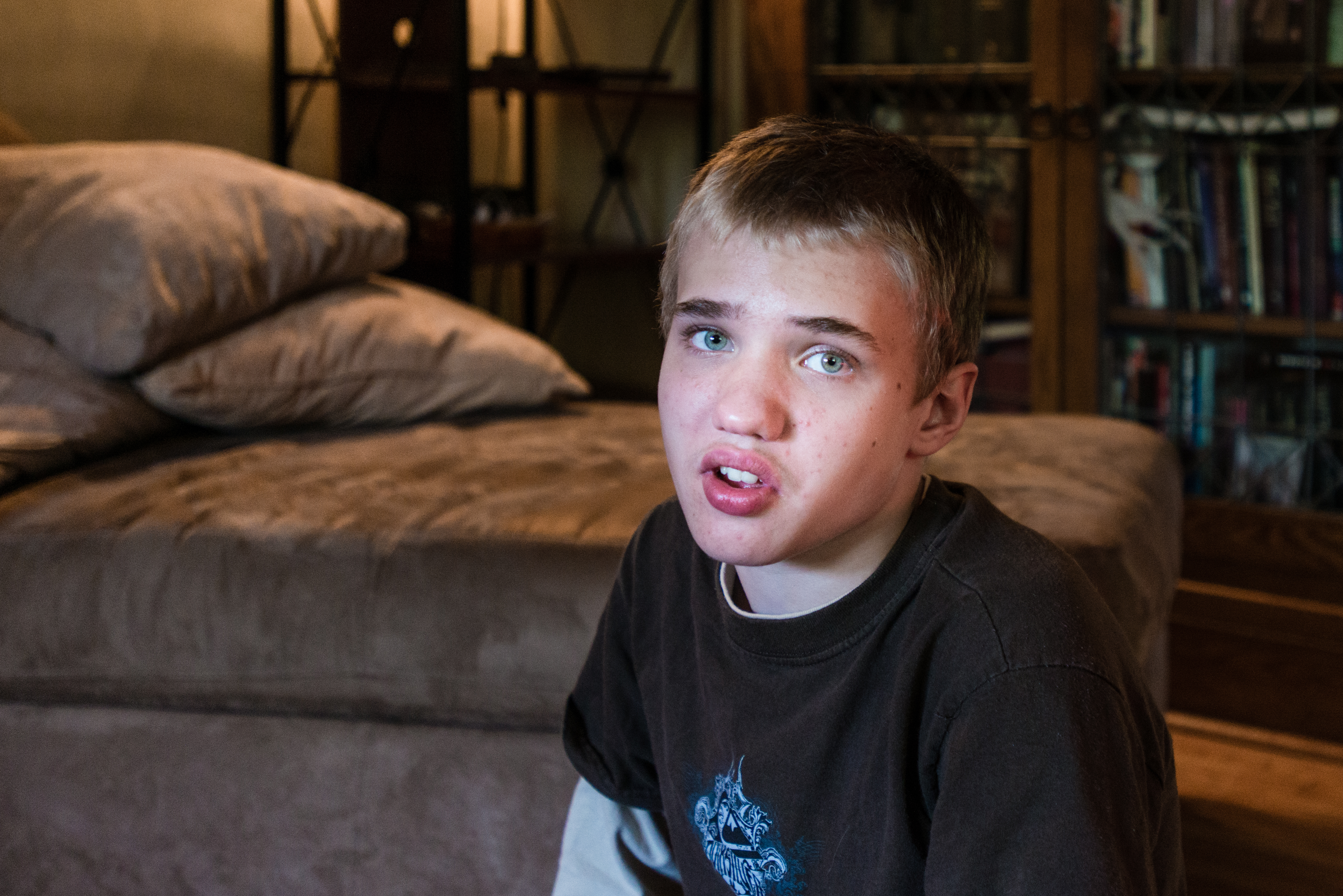 Alexander Brown, 14, sits in his living room on Thursday, May 14, 2015. He was diagnosed with autism at 18 months. Alexander is having a hard time with puberty and is lashing out physically (Photo by Heidi de Marco/KHN).