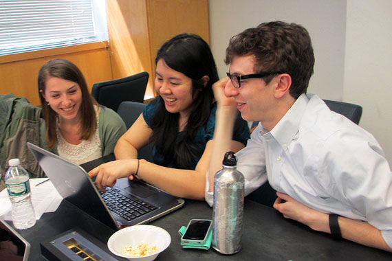(Left to right) Christine Schindler, Mary Quien and Micah Timen hold a study session. Timen worked as an accountant before medical school; his database project tracked the relative costs of a hip replacement throughout New York compared to the relative costs of a fast-food hamburger.(Photo by Cindy Carpien for KHN/NPR)