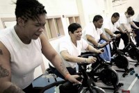 Female inmates take a spinning class