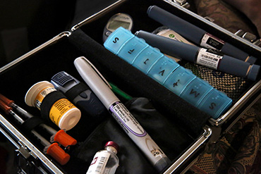 Smith keeps the tools for controlling her diabetes in this kit, which contains metformin, syringes, fast-acting insulin for daytime use and slow-release for overnight. (Photo by Lynn Ischay for NPR)