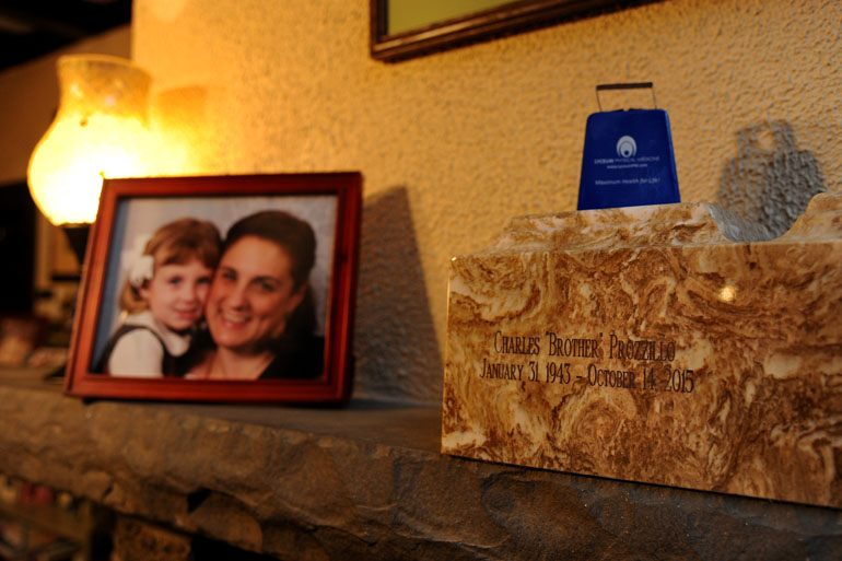 The cremated ashes of Charles Prozzillo are in an urn on the mantle in the Ft. Washington living room of his daughter Ashely Kearsley (in framed portrait with her now ten year old daughter, Chloe Kearsley) January 28, 2016. When Medicare stopped paying for his ambulance rides to dialysis a year ago, his family took him in their car. One day he fell and broke his hip, and died soon after. His grieving family blames the policy change. (Tom Gralish/Philadelphia Inquirer)