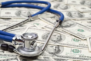 heap of dollars with stethoscope