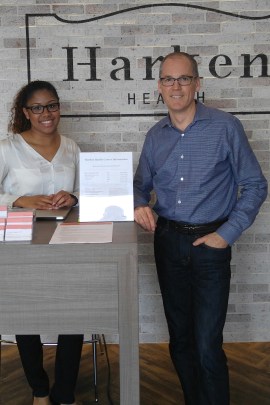 Tom Vanderheyden, CEO OF Harken Health, stands with a greeter at the Austell, Ga., clinic. (Phil Galewitz/KHN)