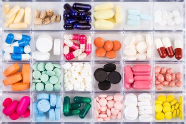Various medicine pills and capsules in plastic container