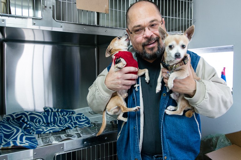 Elvin Quiñones, 55, visits his two chihuahuas at the Santa Fe Animal Hospital usually every other day. Quiñones put them in the kennel the day he became homeless. (Heidi de Marco/KHN)