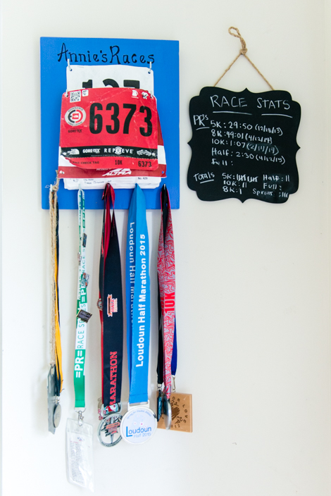 Competition medals and running stats hang in Annie Powell’s house. Powell says fitness and working as a personal trainer contributed to overcoming her depression after giving birth to the twins. (Heidi de Marco/KHN)