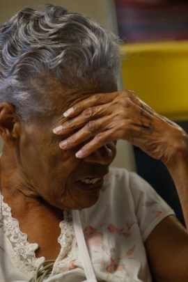 Willie Mae Rich, 86, rests after a short walk around her room. Nurse coordinator Andres Viles told Rich, “This bed is not your friend.” (Hal Yeager for KHN)