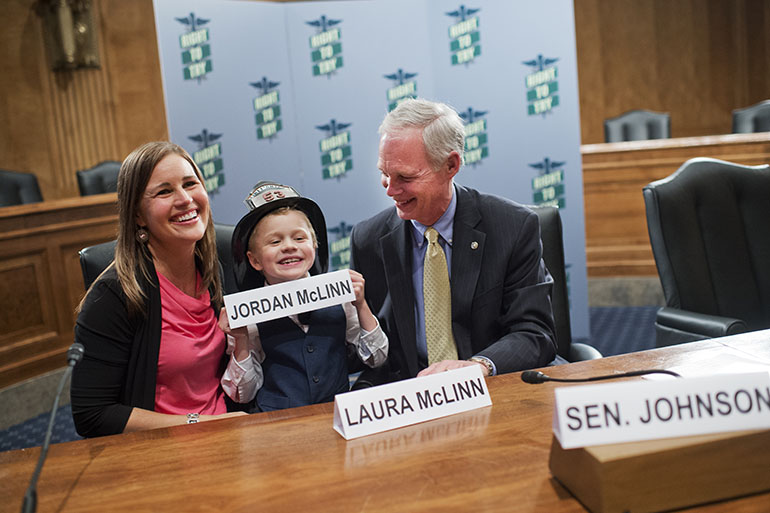 UNITED STATES - MAY 10: From left, Laura McLinn, of Indianapolis, her son Jordan, 7, and Sen. Ron Johnson, R-Wis., pose for a picture after a news conference in Dirksen Building, May 10, 2016, on the "Right to Try" legislation which would allow terminally ill patients, doctors, and pharmaceutical manufacturers to administer investigational treatments when other methods have been exhausted. Jordan suffers from Duchenne muscular dystrophy and his life expectancy is about 20-years-old. (Photo By Tom Williams/CQ Roll Call)