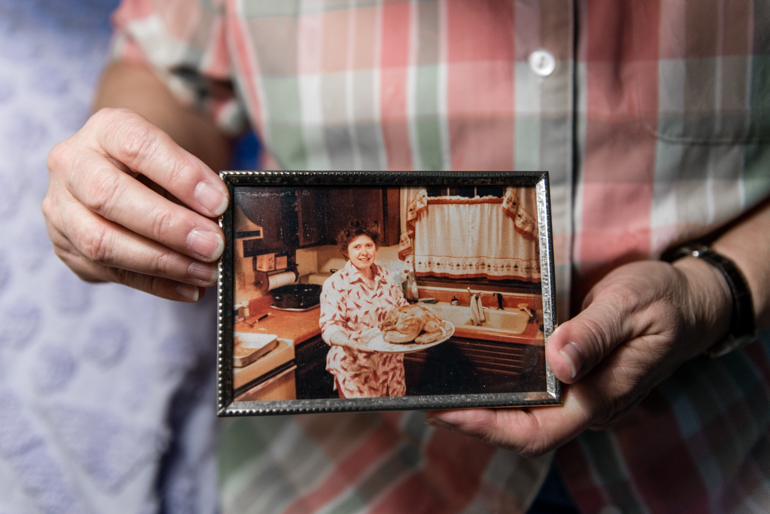Marquardt holds an old photograph of herself of when she was married. Marquardt, a former truck driver who has high blood pressure and kidney disease, came out after raising three children. (Heidi de Marco/KHN)