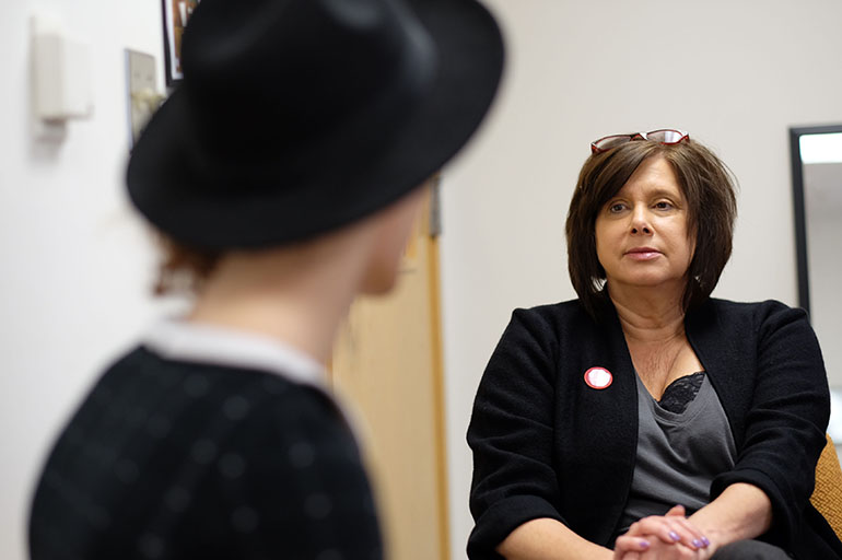 Psychologist Dawn Velligan talks to a client at the transitional care clinic, which aims to prevent people with mental illness from becoming so sick that they need to return to the hospital. (Bahram Mark Sobhani for KHN)