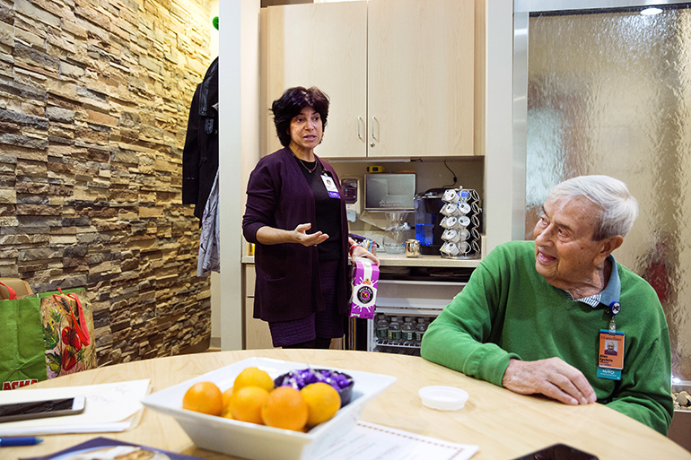 Randi Kaplan and Epstein talk in the caregiver support center at Montefiore Medical Center. (Ben Sklar for KHN)