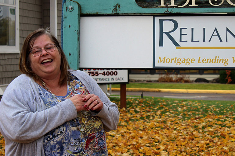 Ruth McCafferty, 53, stands outside her new office in Kalispell, Mont. She says she is “the poster child” for the state’s job training program. (Eric Whitney/Montana Public Radio)