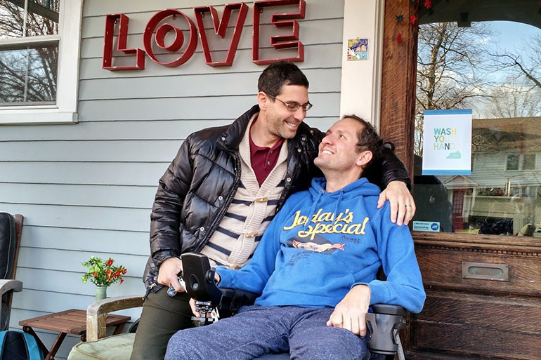 Adox, right, and his husband Danni Michaeli at their home in South Orange, N.J., in fall of 2014. Adox was diagnosed with ALS at age 42 and became almost totally paralyzed within six months. He died last May.