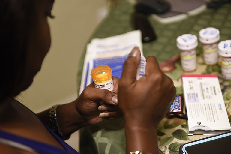 Sharissa Derricott prepares her afternoon medication at her parents’ home in Lawton Okla. After taking Lupron, she’s been diagnosed with degenerative disc disease and fibromyalgia, a chronic pain condition. Her teeth are shedding enamel and cracking. (Nick Oxford/for KHN)