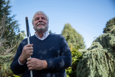 Bryan Bashin who is blind holds walking aid