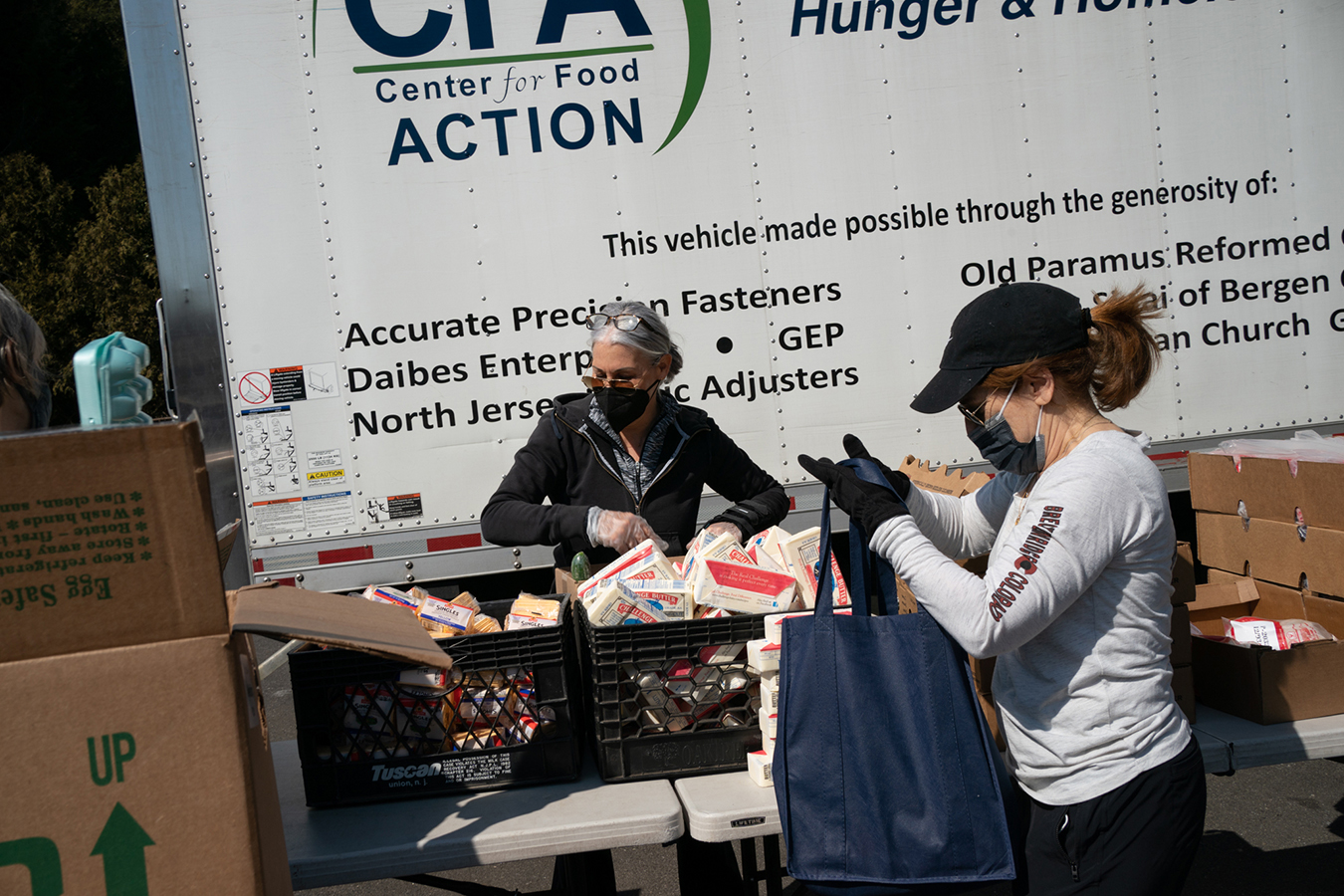 Food pantry volunteers prepare packages of food