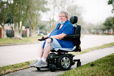 Maria Skladzien sits in her wheelchair on a sidewalk