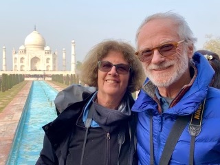 two seniors pose in front of the Taj Mahal