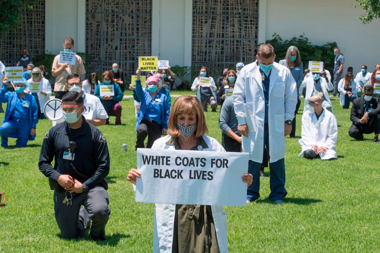 Doctors, nurses and other health care workers participate in a "White Coats for Black Lives" event in solidarity with George Floyd and other black Americans killed by police officers.