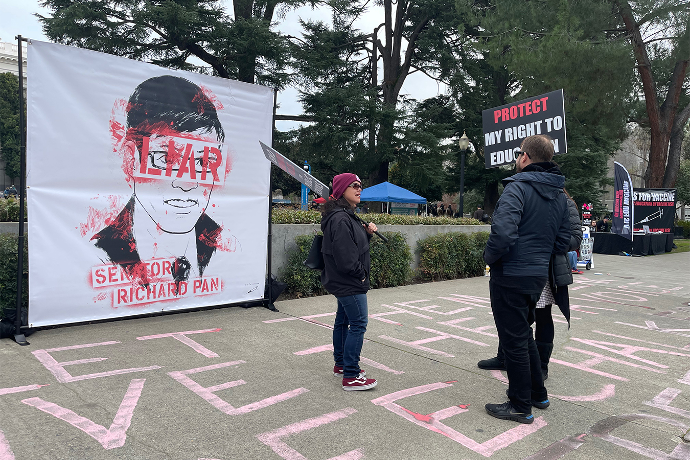 A poster of California Sen. Richard Pan (D-Sacramento) is smeared with red at an anti-vaccine protest at the California Capitol in early January.