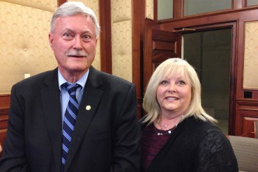 Missouri Reps. Lynn Morris and Tricia Derges stand together in a room inside the Missouri Capitol building. Both are looking at the camera and smiling.