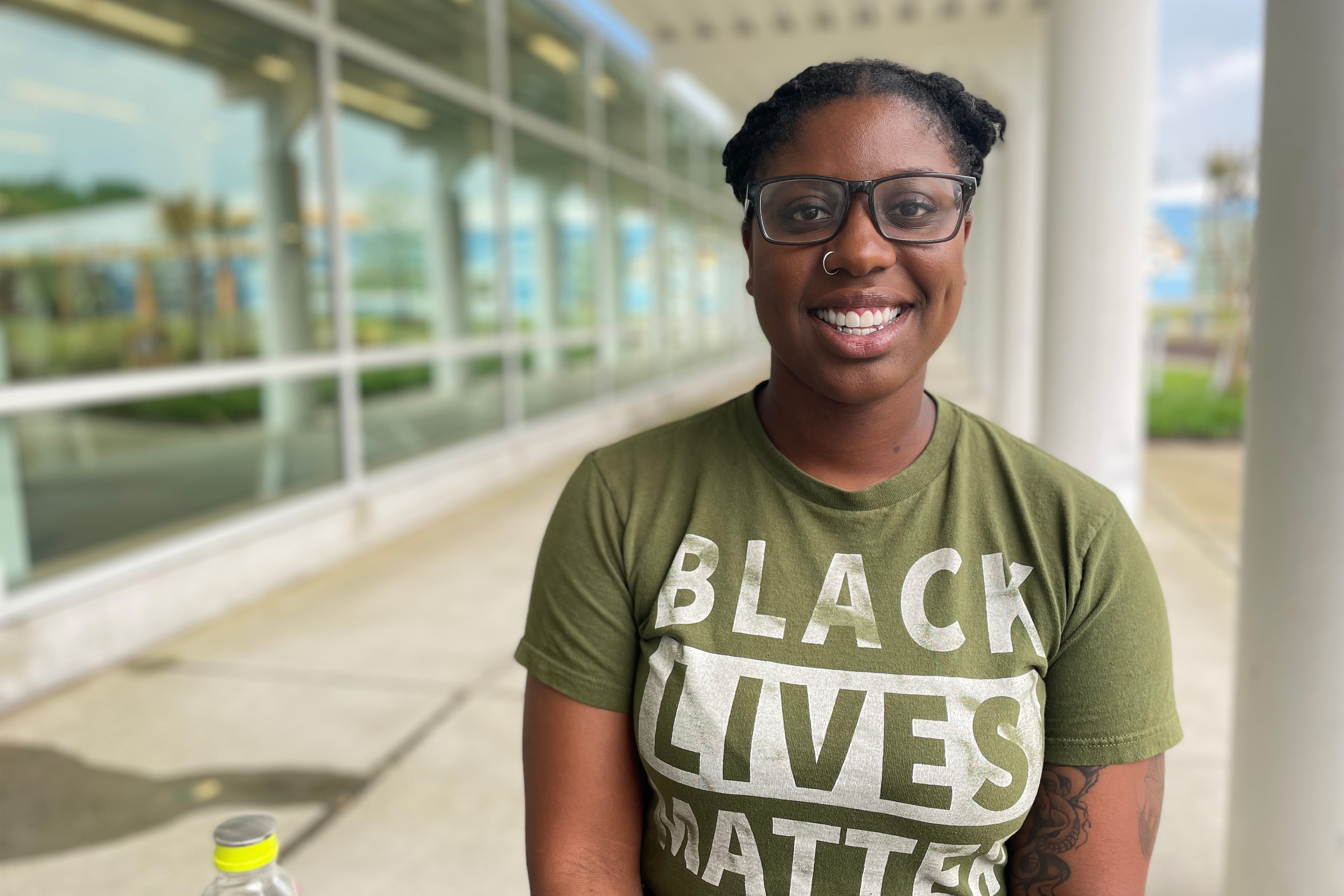 A portrait photo shows Tia Freeman smiling, wearing a green shirt with text that reads, "BLACK LIVES MATTER."