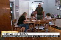 A still from a video shows the Ward family sitting at a table. Text over the image reads, "Medical debt crisis: Couple exhausts savings & retirement after incurring medical debt."