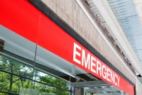A photo shows an emergency room sign outside of a hospital.