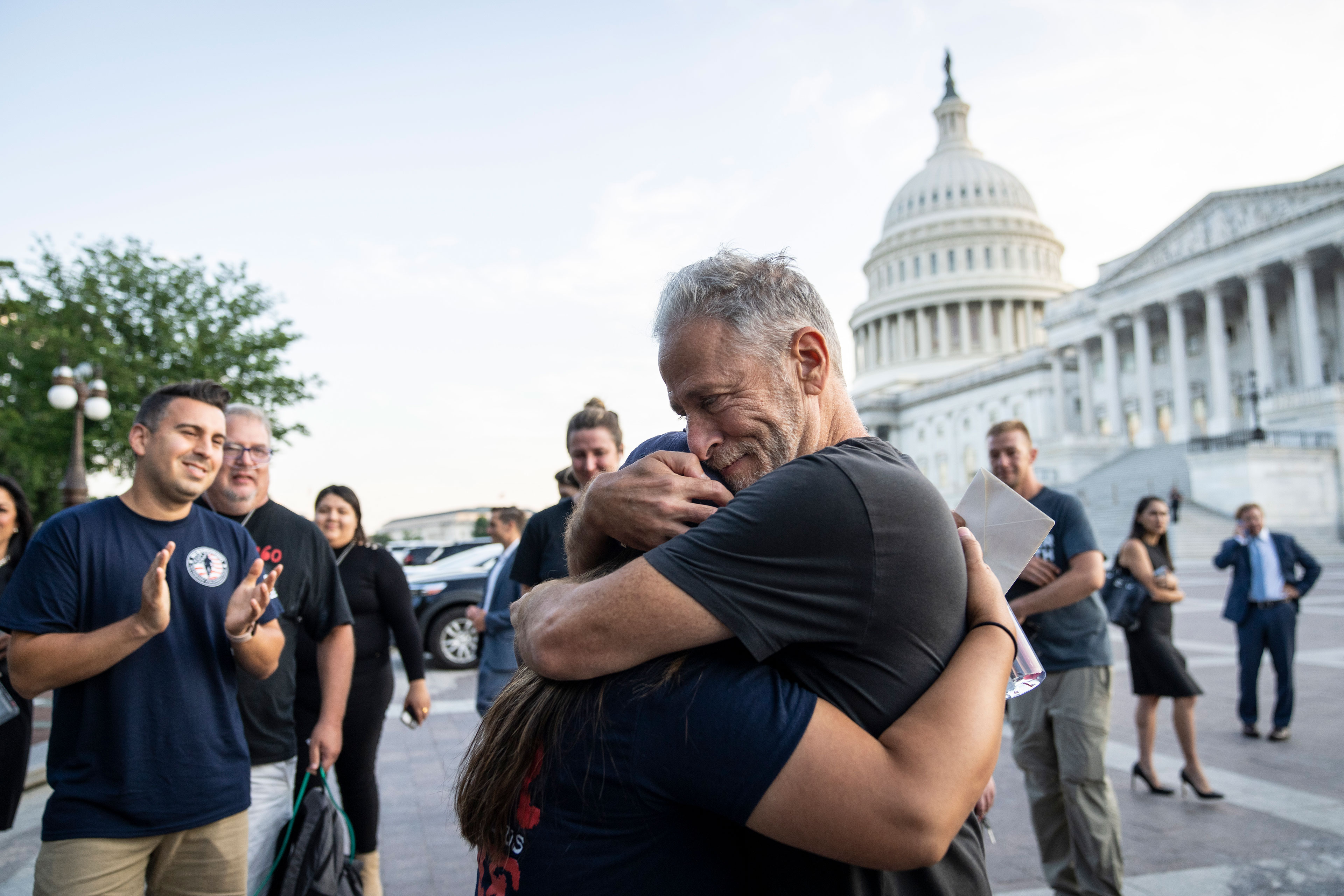 A woman and a man hug outside the Capitol building.
