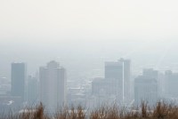 A photo shows a city skyline obscured by thick smog.
