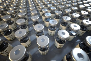 A macro photo of covid-19 vaccine bottles. The bottles take up the entire image.