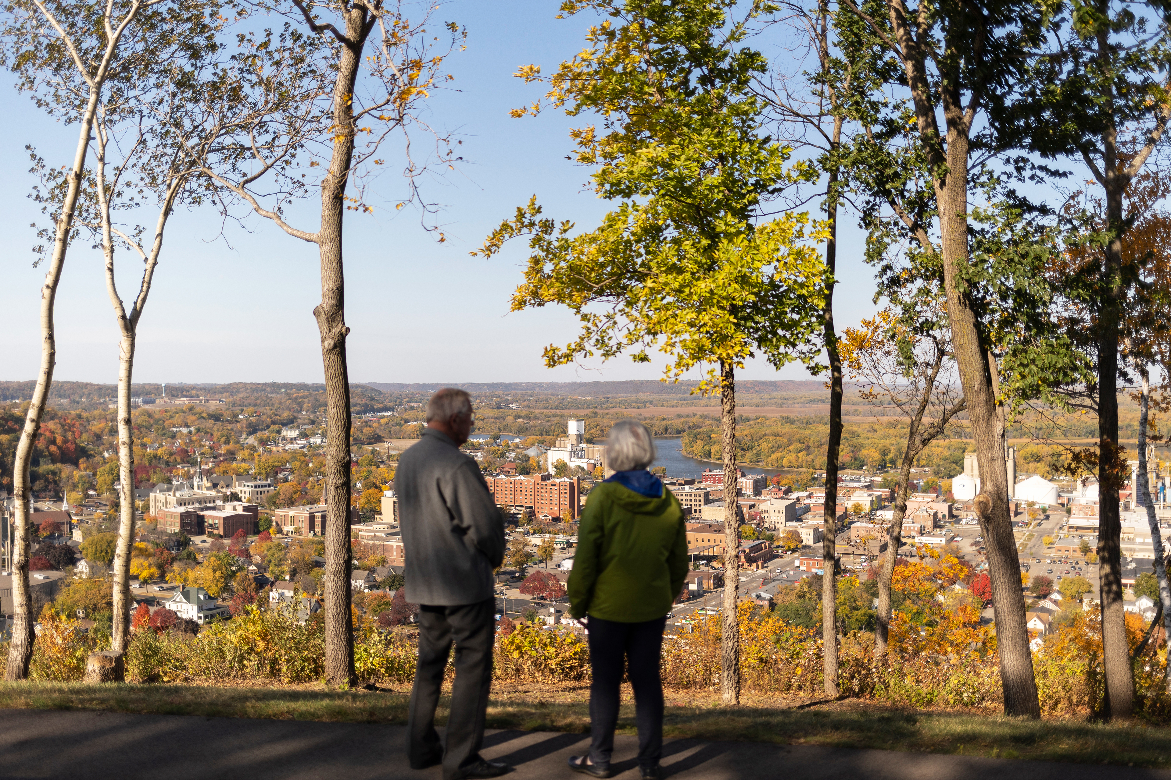 A photo shows Jim and Judie Maybach standing on a hill overlooking the city of Red Wing, Minnesota.