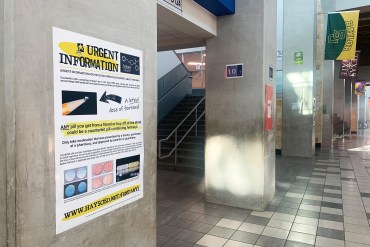A photo shows a poster warning of the dangers of fentanyl use in a high school hallway.